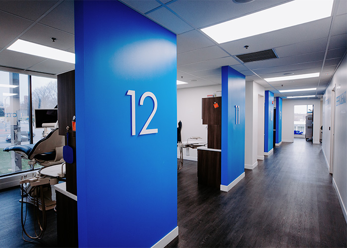 Hallway of dental exam rooms at keith + associates dentistry in Mission, KS.