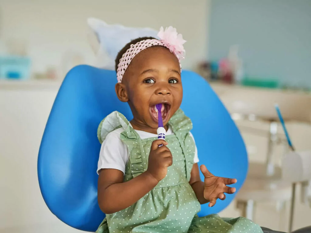 smiling child with a toothbrush